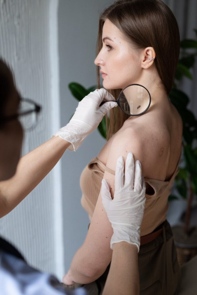 female doctor diagnosing melanoma body female patient